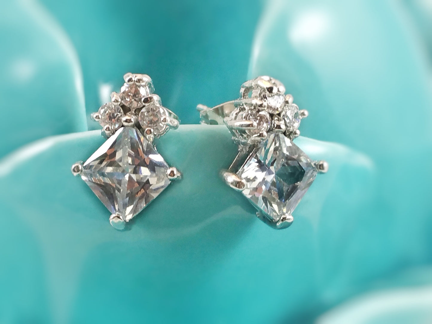 7mm princess cut with three stone stud earrings, April birthstone